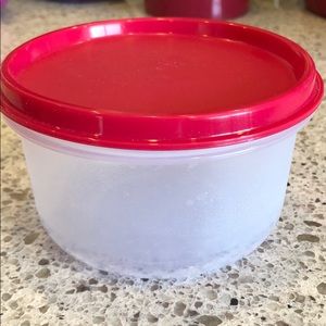 Clear plastic bowl with red lid
